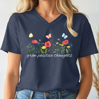 Navy blue v-neck t-shirt with floral design and 'grow positive thoughts' text worn by a person.