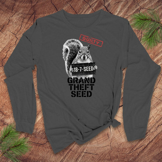 Asphalt long-sleeve shirt with a graphic of a squirrel holding a seed packet and text, 'guilty. grand theft seed' on a wooden surface.
