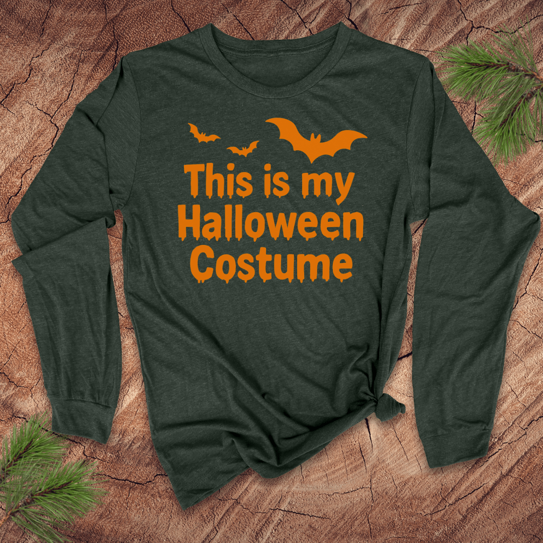 Green long-sleeve shirt with 'This is my Halloween Costume' text and orange bats on a wooden surface.