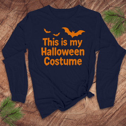 Navy blue long-sleeve shirt with orange text 'This is my Halloween Costume' on a wooden surface.