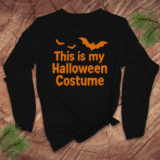 Black sweatshirt with 'This is my Halloween Costume' text and bat graphics on a wooden surface.