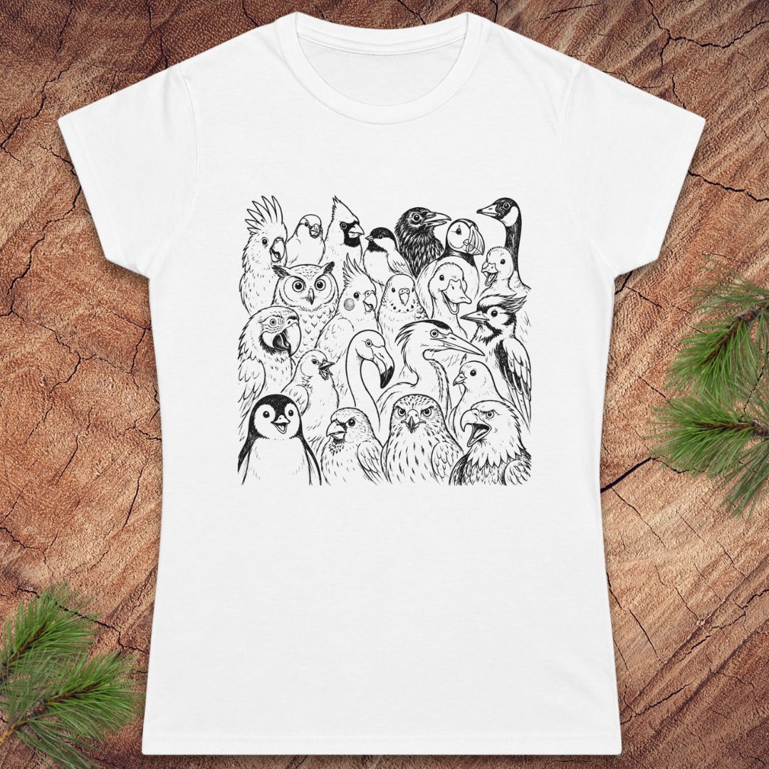 A white short-sleeve crewneck t-shirt featuring a black line art graphic of various birds, displayed flat on a rustic wood background with pine needles in the corners.