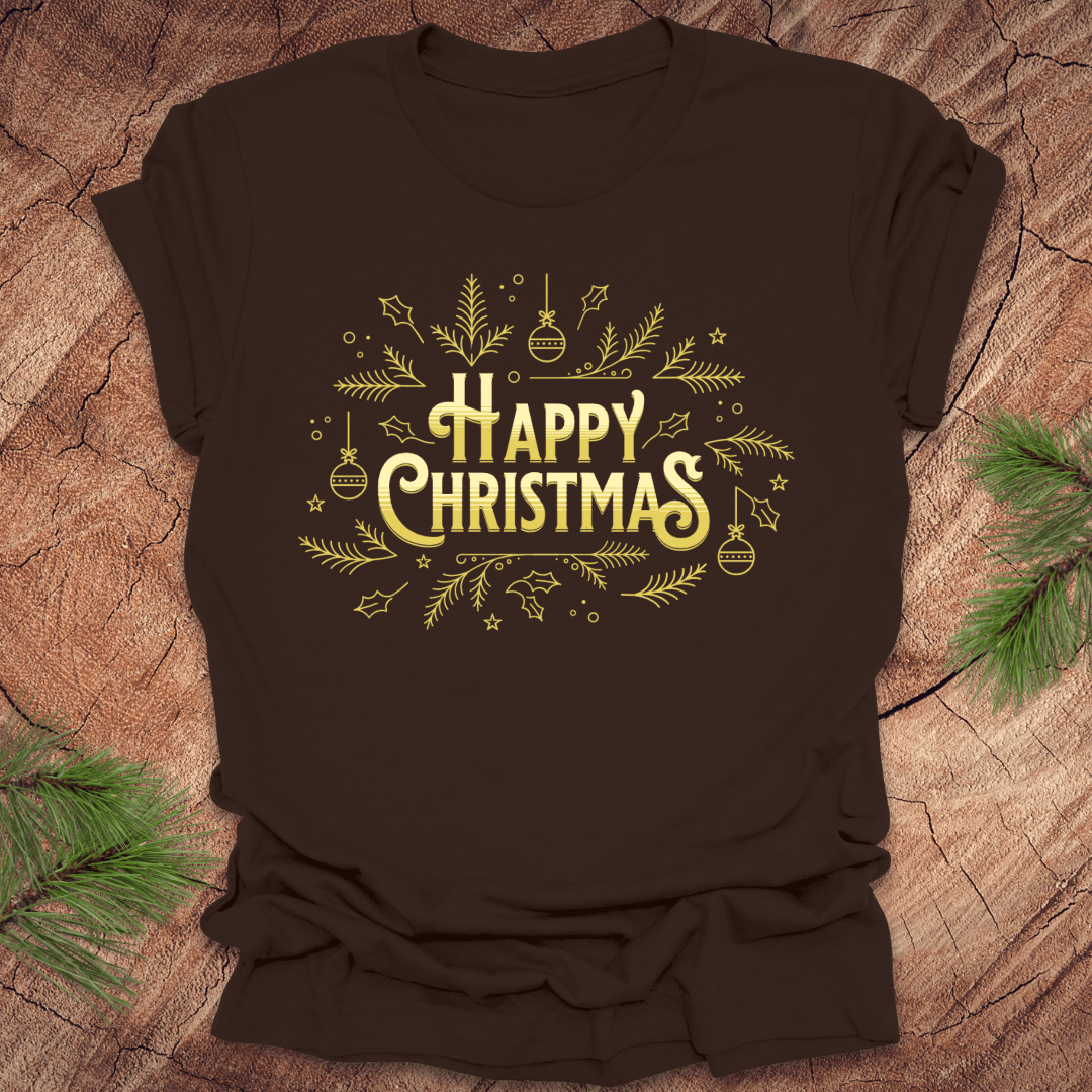 Brown t-shirt with 'Happy Christmas' text and pine graphics on a wooden surface with pine branches.