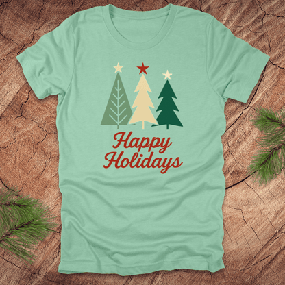 Light blue t-shirt with Christmas tree design and 'Happy Holidays' text on a wooden surface.