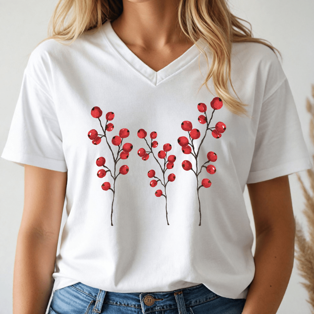Person wearing a white v-neck t-shirt with 3 holly branches with berries on a plain white background.