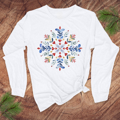 White long-sleeve shirt with a colorful floral pattern on a wooden surface