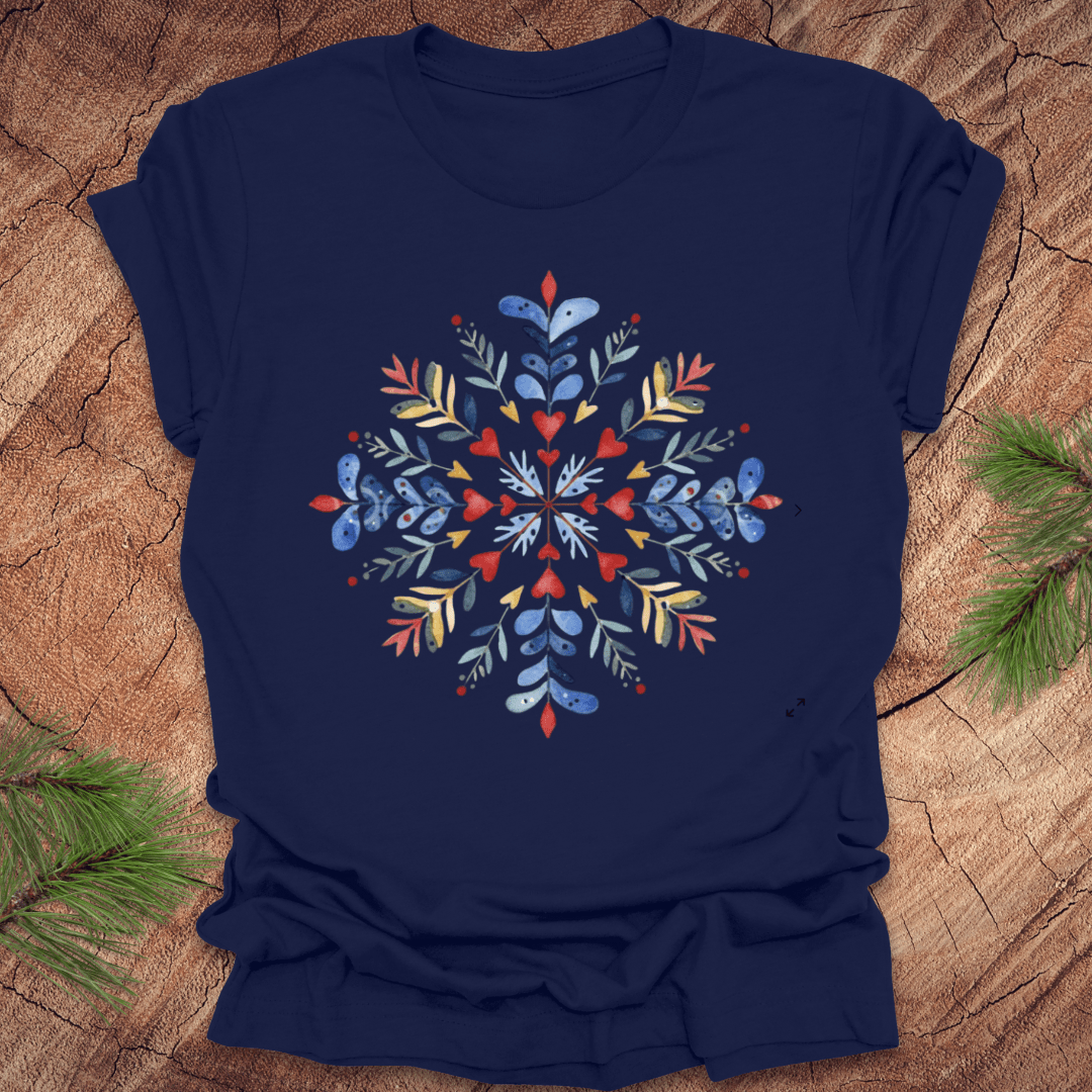 Navy t-shirt with a colorful snowflake floral design on a wooden surface