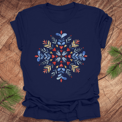 Navy t-shirt with a colorful snowflake floral design on a wooden surface