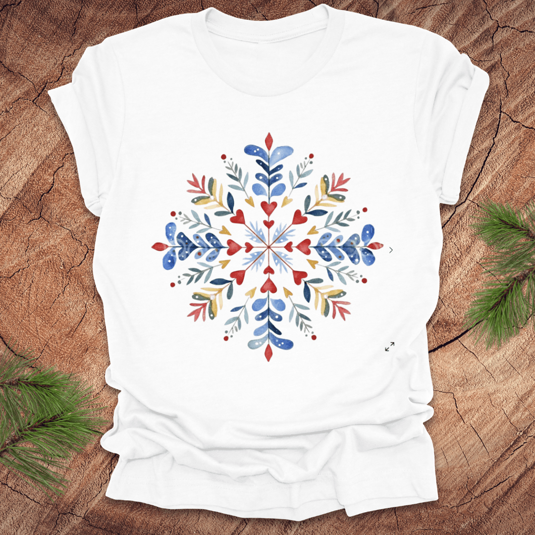 White t-shirt with a colorful snowflake floral design on a wooden surface