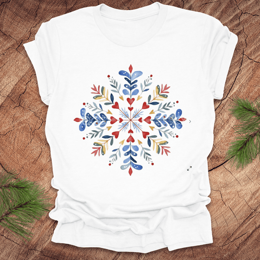 White t-shirt with a colorful snowflake floral design on a wooden surface