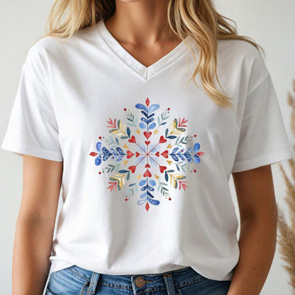 Person wearing a white t-shirt with a colorful floral design on a plain background