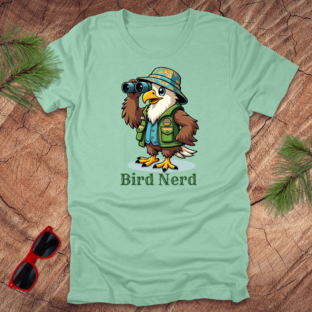 Mint-green t-shirt with an animated eagle in birdwatching gear with "bird nerd" text on a wood background.