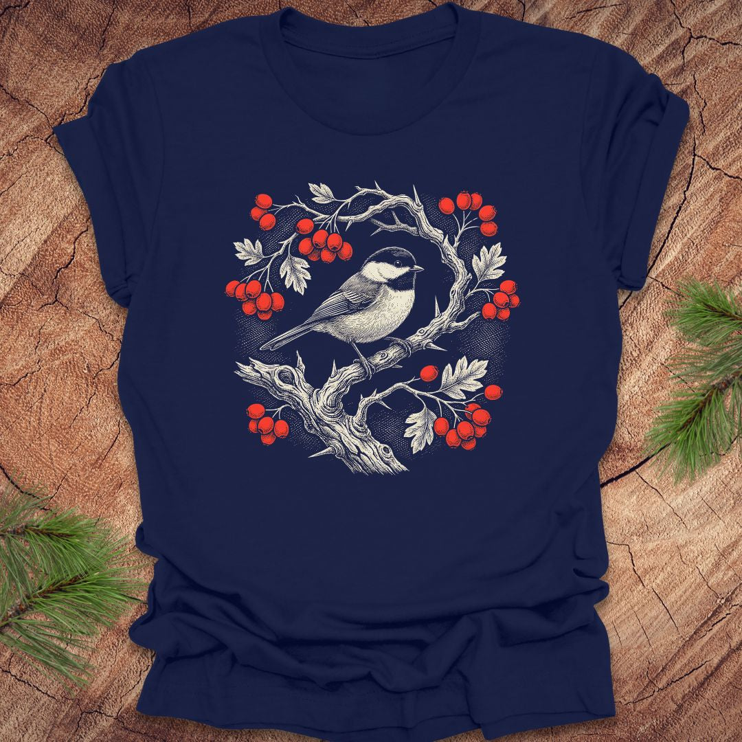 Navy blue t-shirt with a chickadee and holly  berry design on a wooden surface