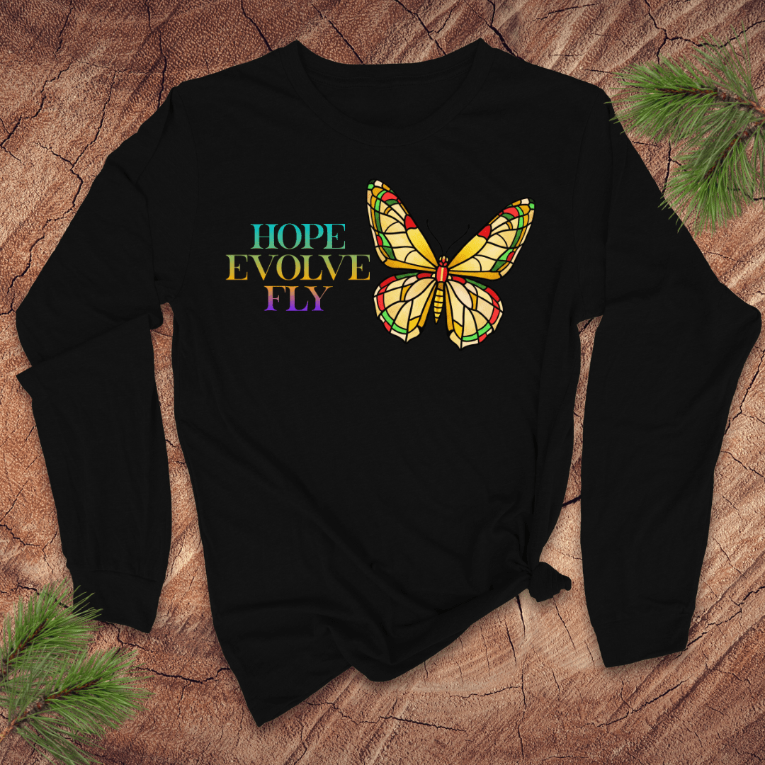 Black long sleeve tshirt with a colorful butterfly graphic and text on a textured surface.