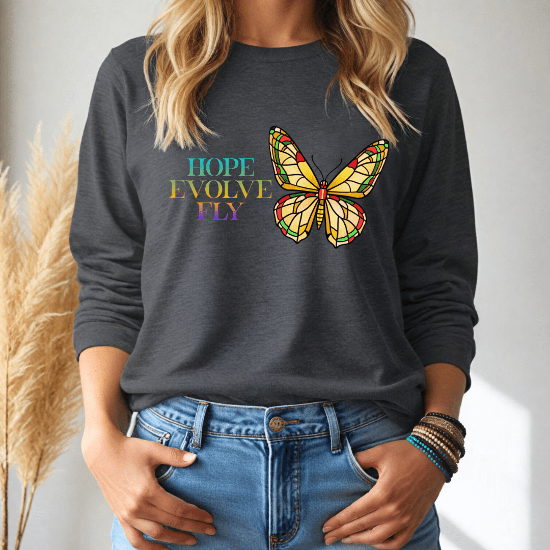 Person wearing a dark gray long sleeve tshirt with a colorful butterfly design and text.