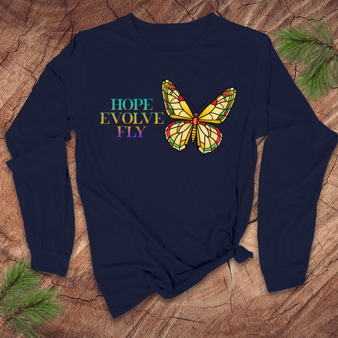 Navy blue long-sleeve shirt with a colorful butterfly graphic and text on a wooden surface.
