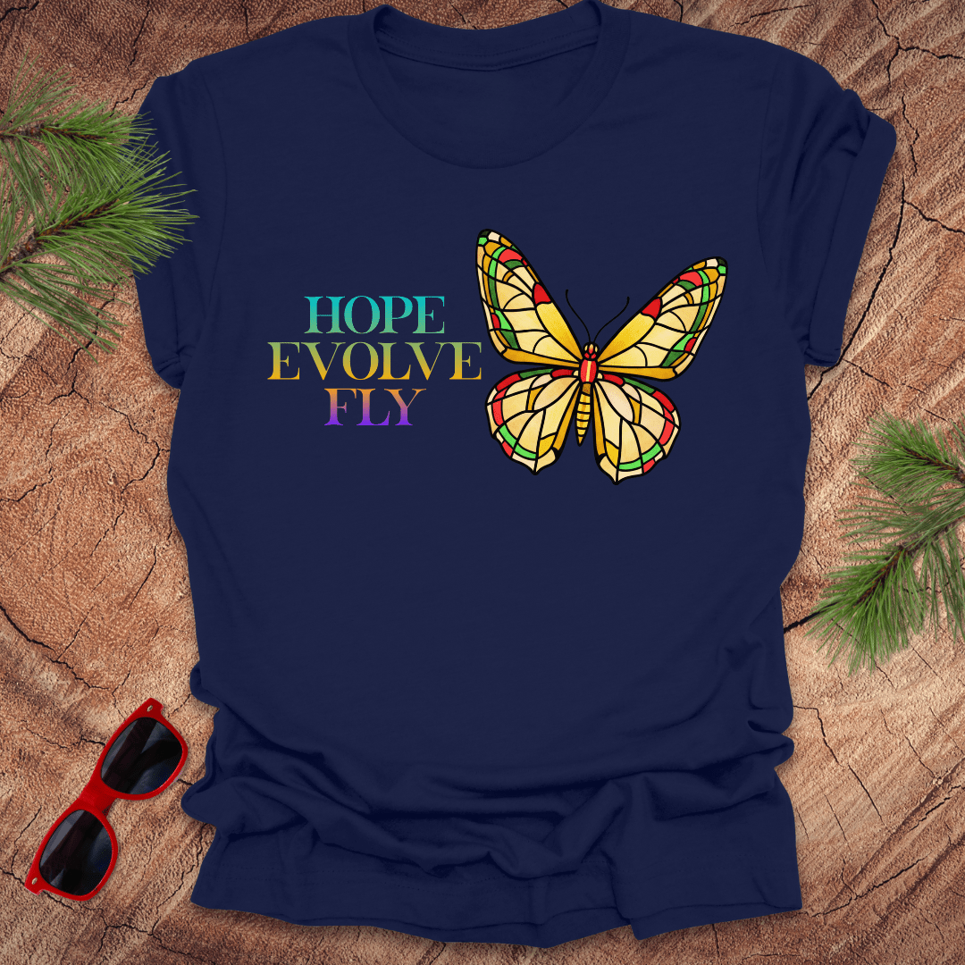 Navy blue t-shirt with a colorful butterfly graphic and motivational text on a wooden surface.