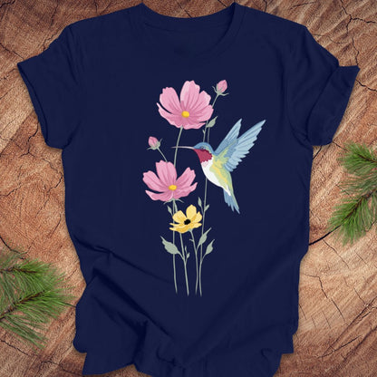 Navy blue t-shirt with a hummingbird and floral design on a wooden surface.