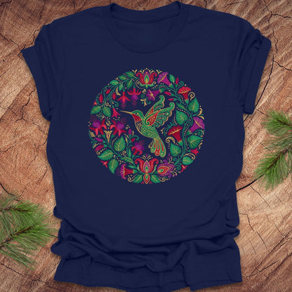 Navy blue t-shirt with a colorful hummingbird and floral design on a wooden surface.