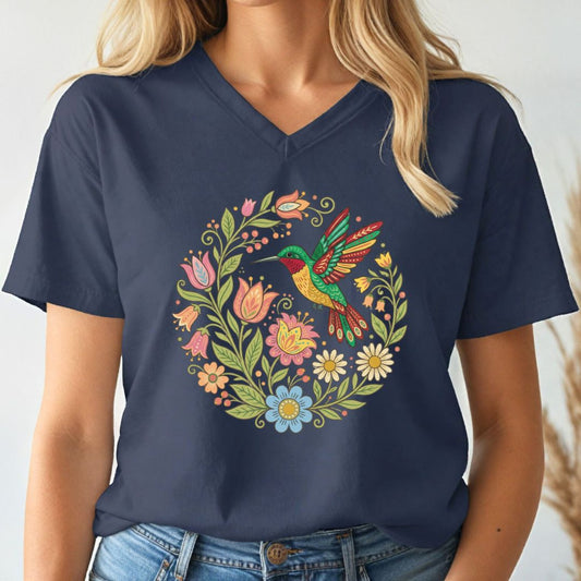 Navy blue v-neck t-shirt with a colorful bird and floral design worn by a person.