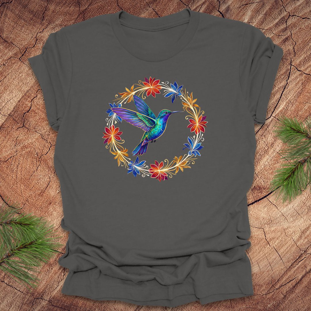 Gray t-shirt with a colorful hummingbird design on a wooden surface