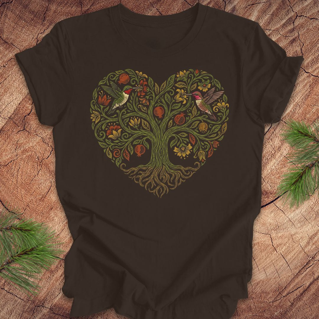 Brown t-shirt with a heart-shaped tree design featuring hummingbirds on a wooden surface.