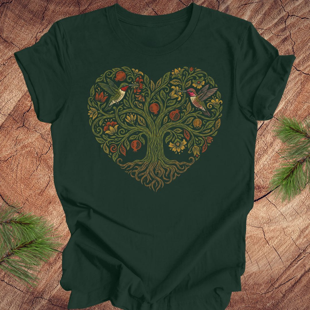 Green t-shirt with a heart-shaped tree design featuring hummingbirds on a wooden surface.