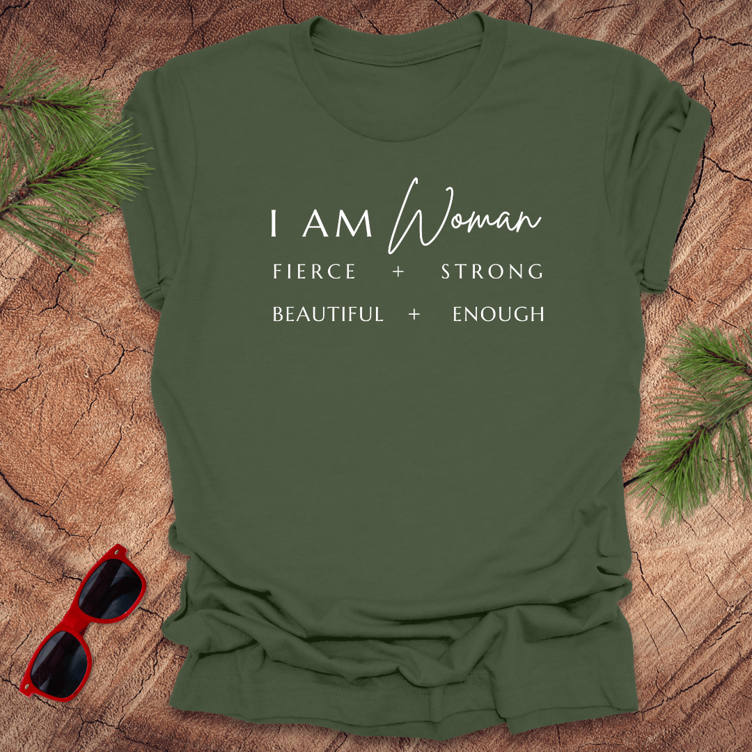 A green unisex short-sleeve t-shirt with the text 'I AM Woman Fierce. Strong. Beautiful. Enough.' printed in white.