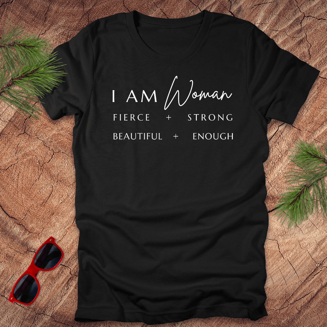A black heather unisex short-sleeve t-shirt with the text 'I AM Woman Fierce. Strong. Beautiful. Enough.' printed in white.