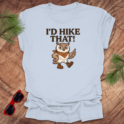 A light blue t-shirt with a graphic of an owl wearing a hat and the text 'I'D HIKE THAT!' printed above.