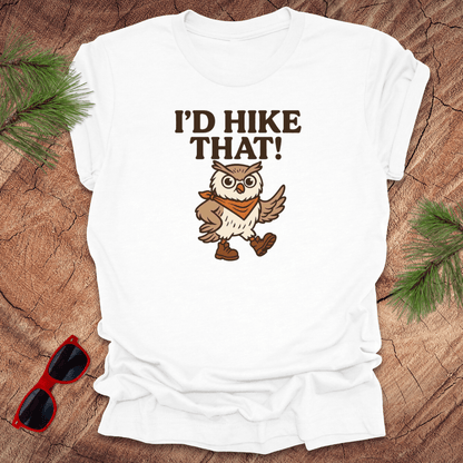 A white t-shirt with a graphic of an owl wearing a hat and the text 'I'D HIKE THAT!' printed above.