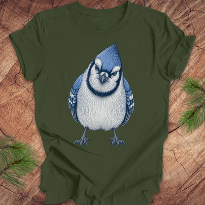 Green t-shirt with a blue and white bird design on a wooden surface.