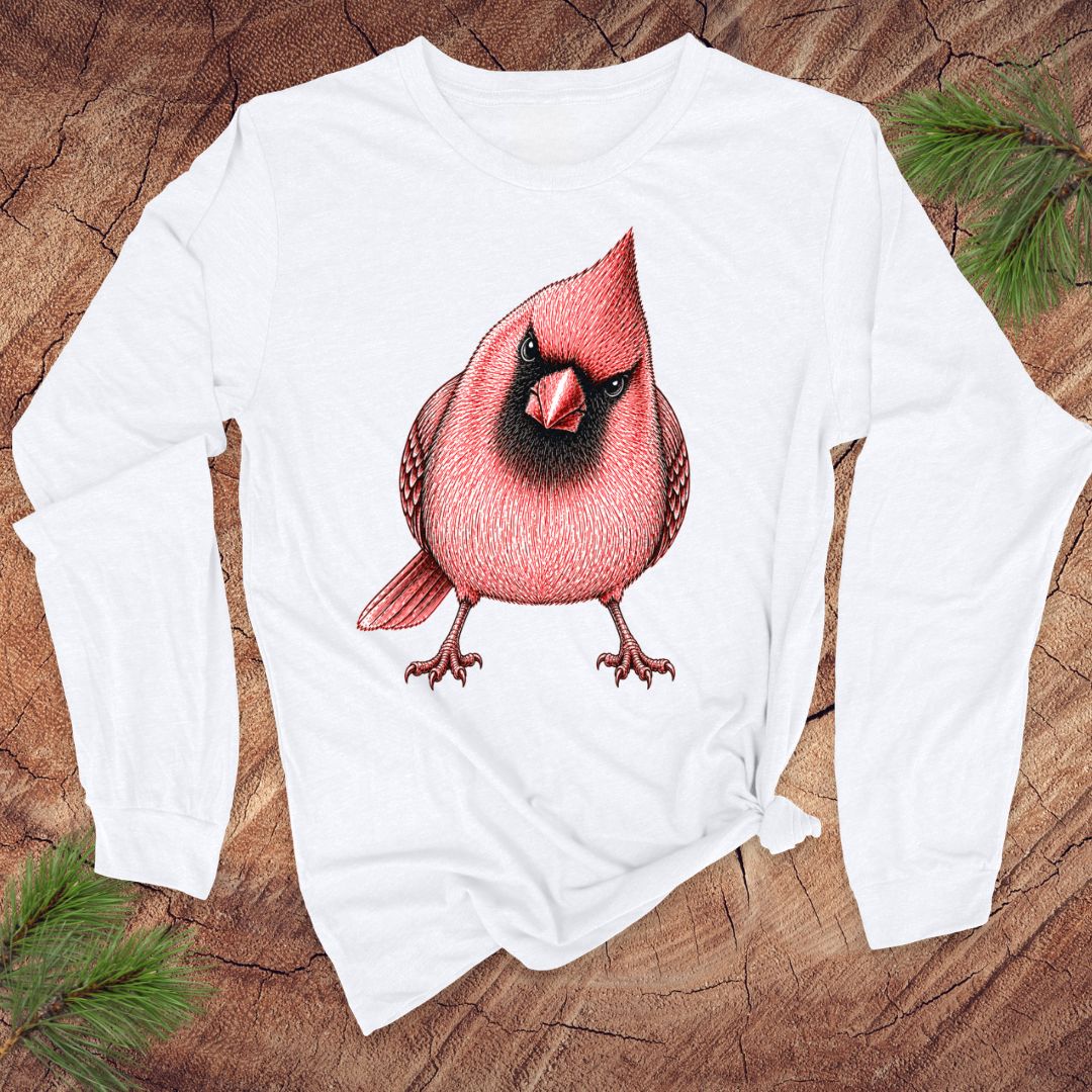 White long-sleeve shirt with a red cardinal bird design on a wooden surface.