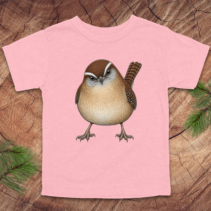 Pink toddler t-shirt with a carolina wren design on a wooden surface