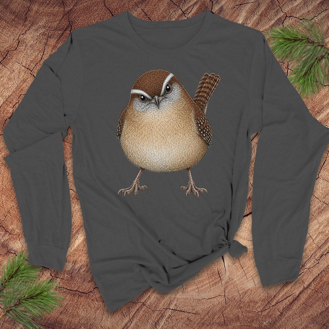 Gray long-sleeve t-shirt with a carolina wren design on a wood background.