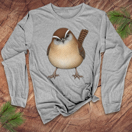 Gray long-sleeve t-shirt with a carolina wren design on a wood background.