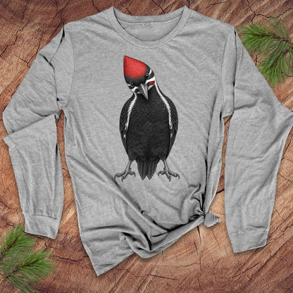 Gray long-sleeve shirt with a woodpecker design on a wooden surface with pine branches.
