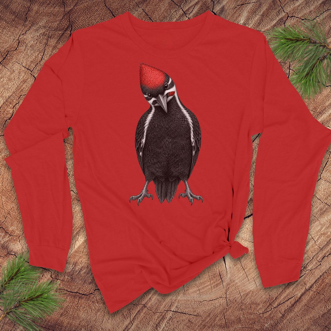 Red long-sleeve shirt with a woodpecker design on a wooden surface.