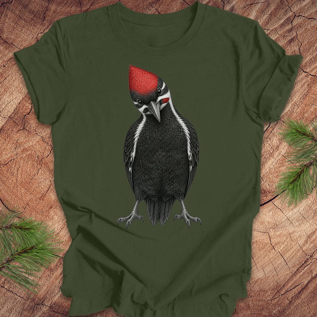 Green t-shirt with a woodpecker design on a wooden surface