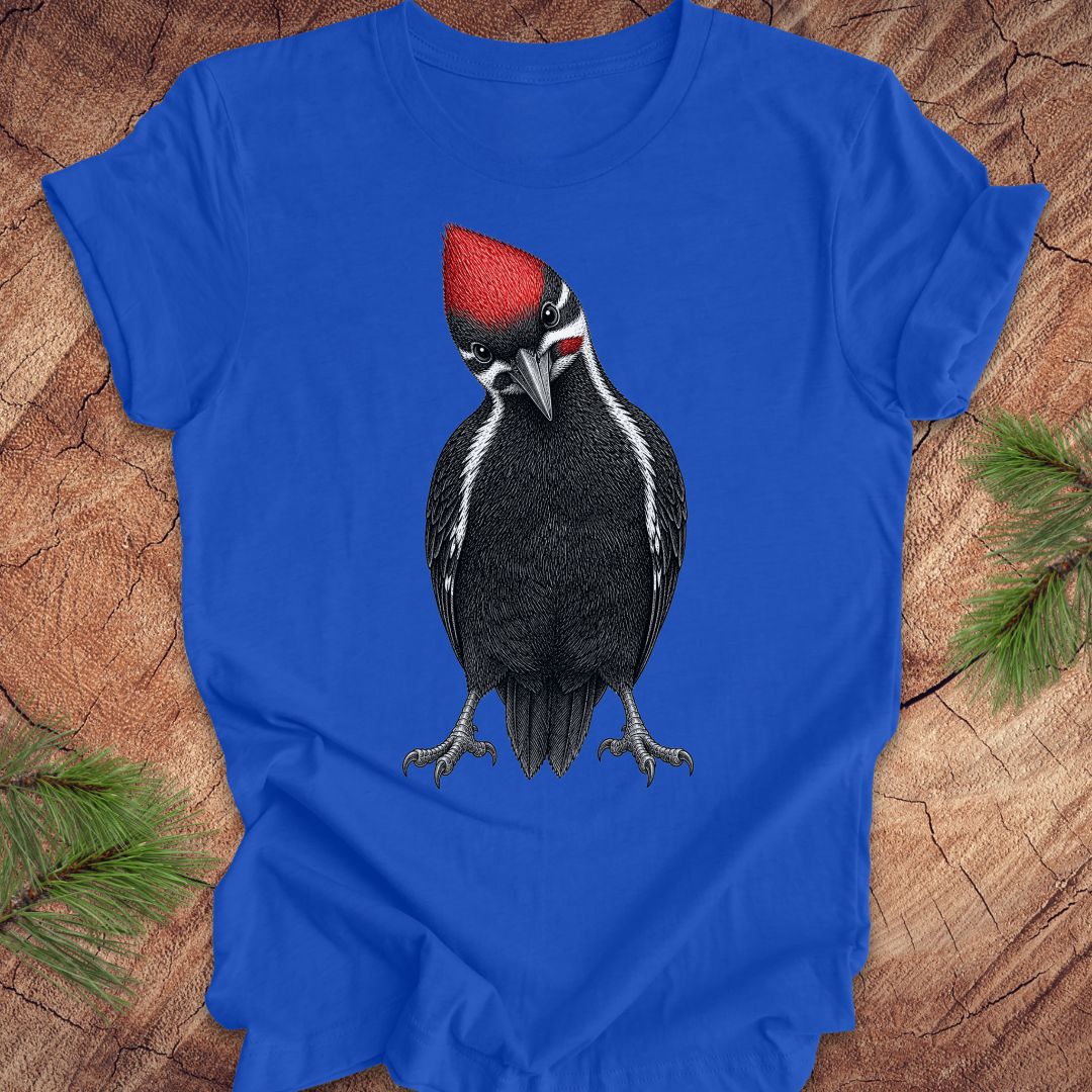 Blue t-shirt with a woodpecker design on a wooden surface