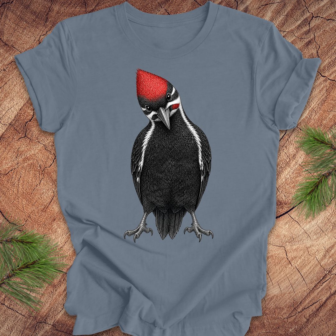Blue t-shirt with a woodpecker design on a wooden surface