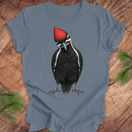 Blue t-shirt with a woodpecker design on a wooden surface