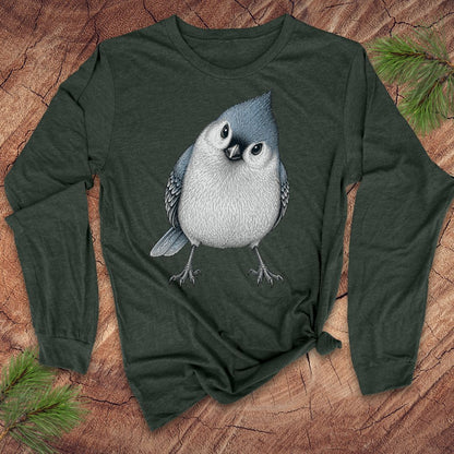 Green long-sleeve t-shirt with a titmouse graphic on a wood background.