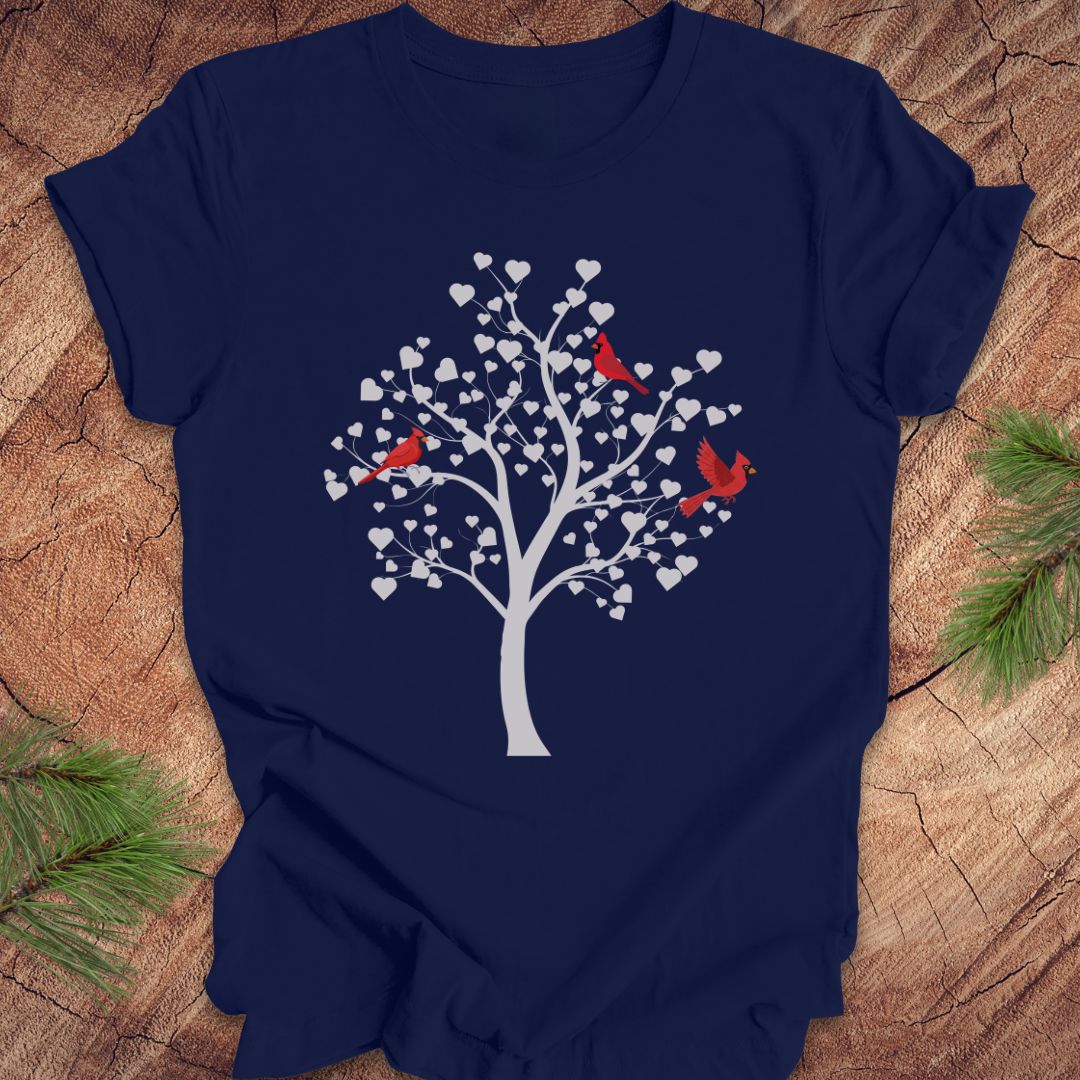 Navy blue t-shirt with a tree and birds design on a wooden surface