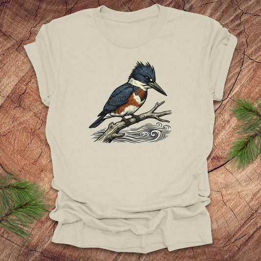 Beige t-shirt with a kingfisher bird design on a wooden surface