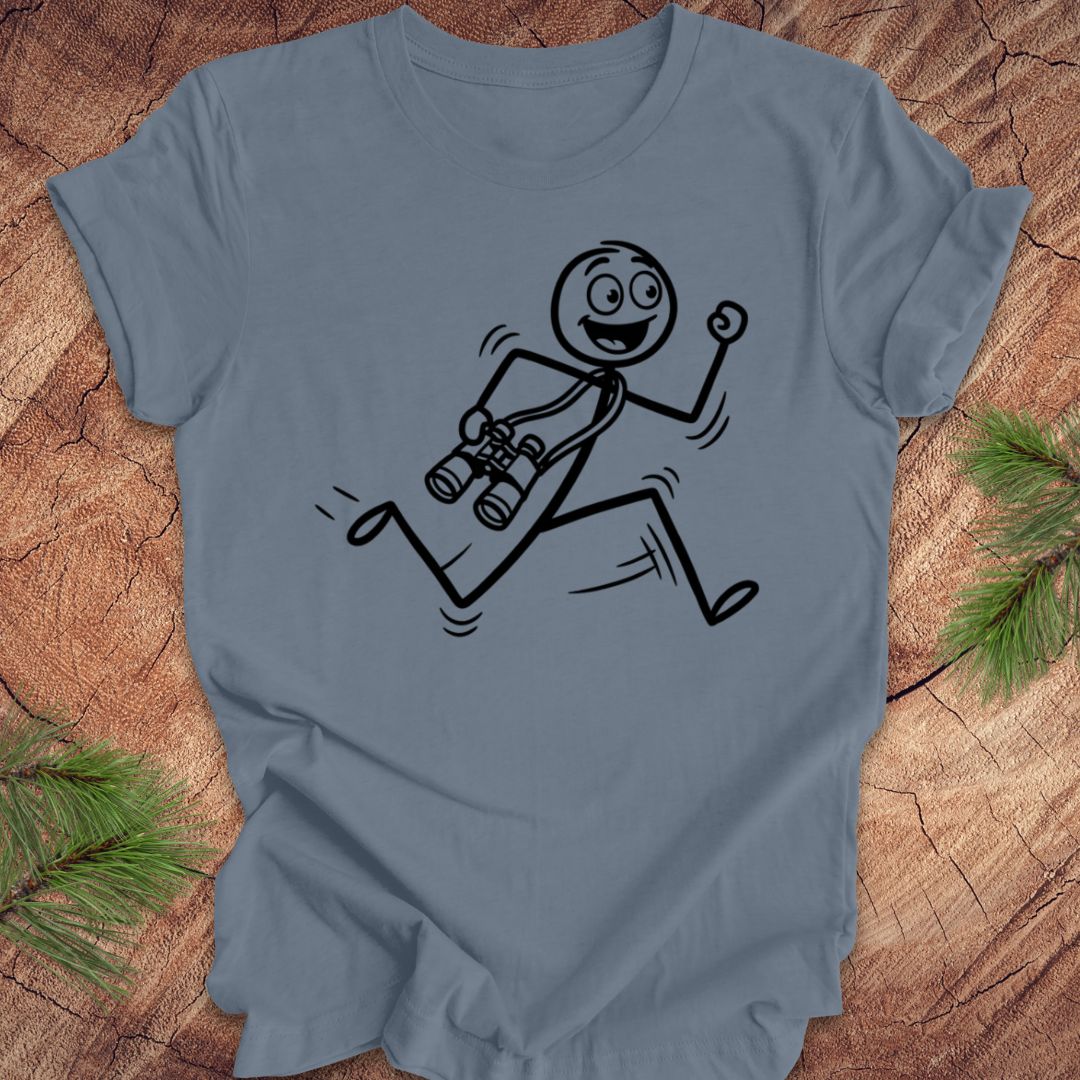 Blue t-shirt with a stick figure design running with binoculars on a wooden surface
