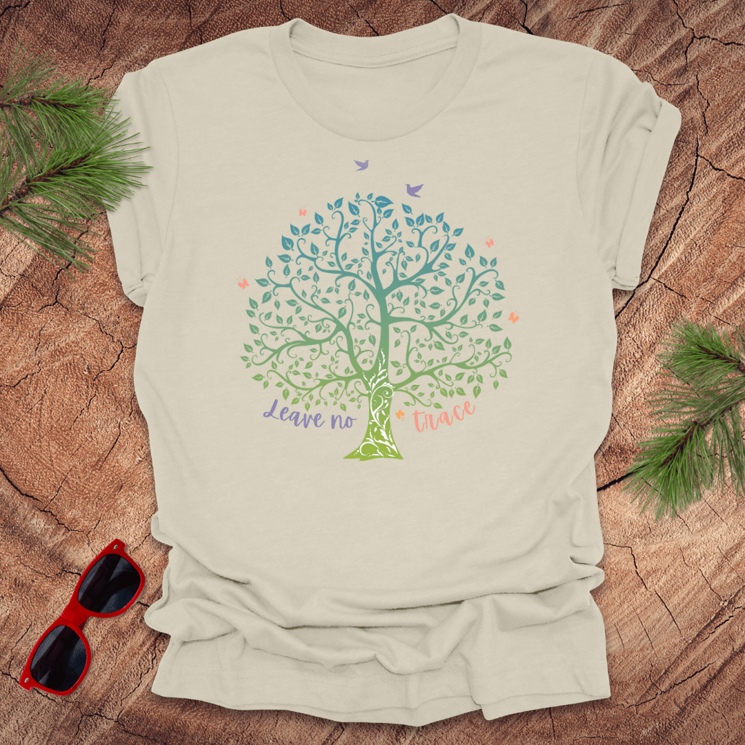 A beige t-shirt with a graphic of a tree and the phrase 'Leave no Trace', surrounded by leaves and birds.