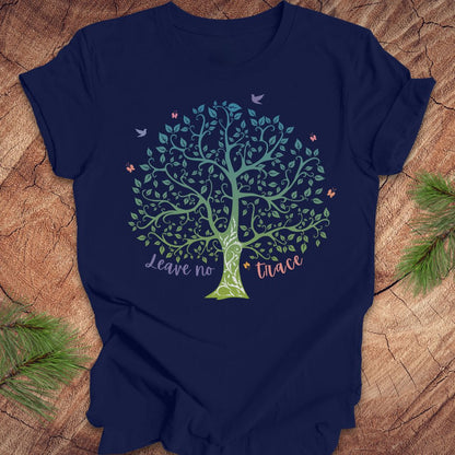 Navy blue t-shirt with a tree design and 'Leave no trace' text on a wooden surface.