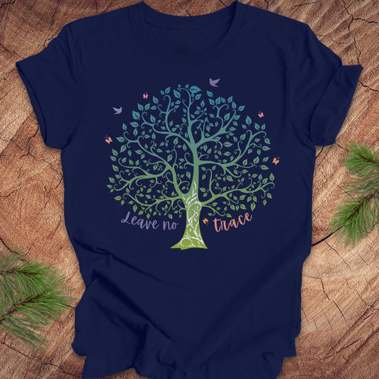Navy blue t-shirt with a tree design and 'Leave no trace' text on a wooden surface.