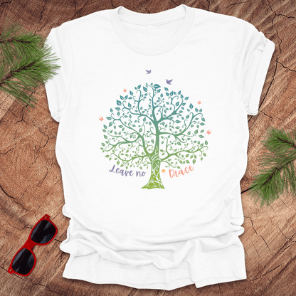 A white t-shirt with a graphic of a tree and the phrase 'Leave no Trace', surrounded by leaves and birds.